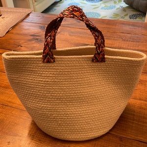 Anthropologie Bucket Tote NWOT W multicolor woven leather straps.